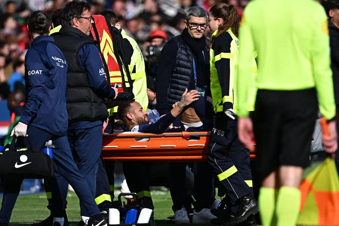 Neymar was taken off on a stretcher with an ankle injury in the second half of PSG’s Ligue 1 win over Lille.