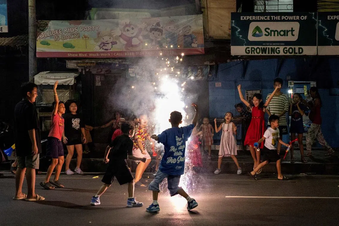 Children playing during New Year's Eve celebrations at a street in Mandaluyong, Metro Manila, Philippines, Dec 31, 2023.