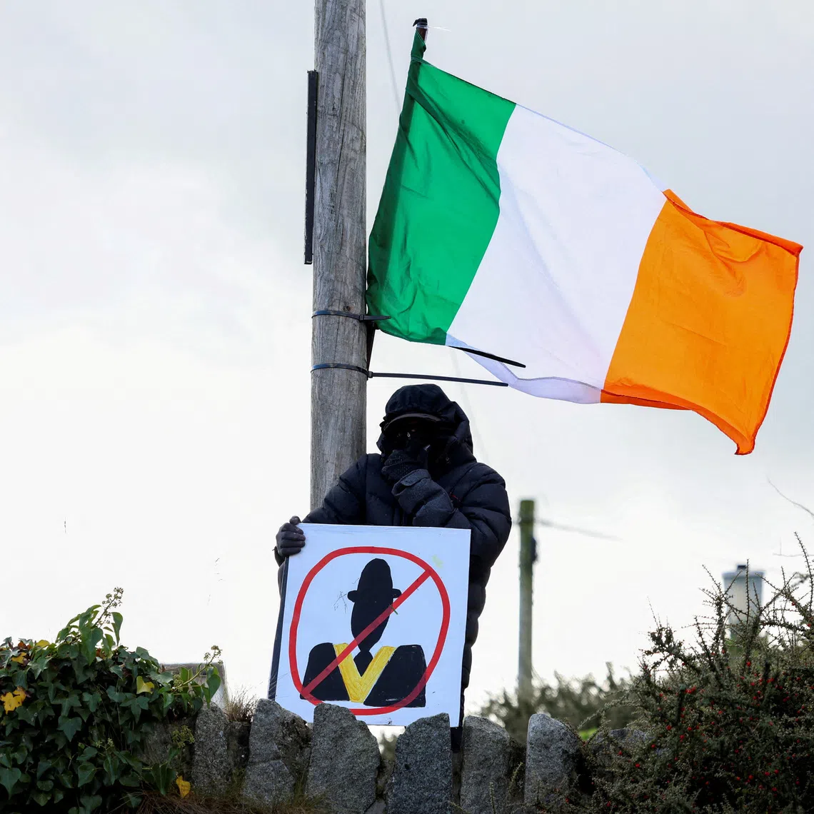 A demonstrator holds a placard, as people protest on the Garvaghy Road, a Catholic enclave in the largely Protestant town of Portadown, against the Protestant Orange Order's annual Drumcree parade, in Northern Ireland, September 27, 2026. REUTERS/Cathal McNaughton
