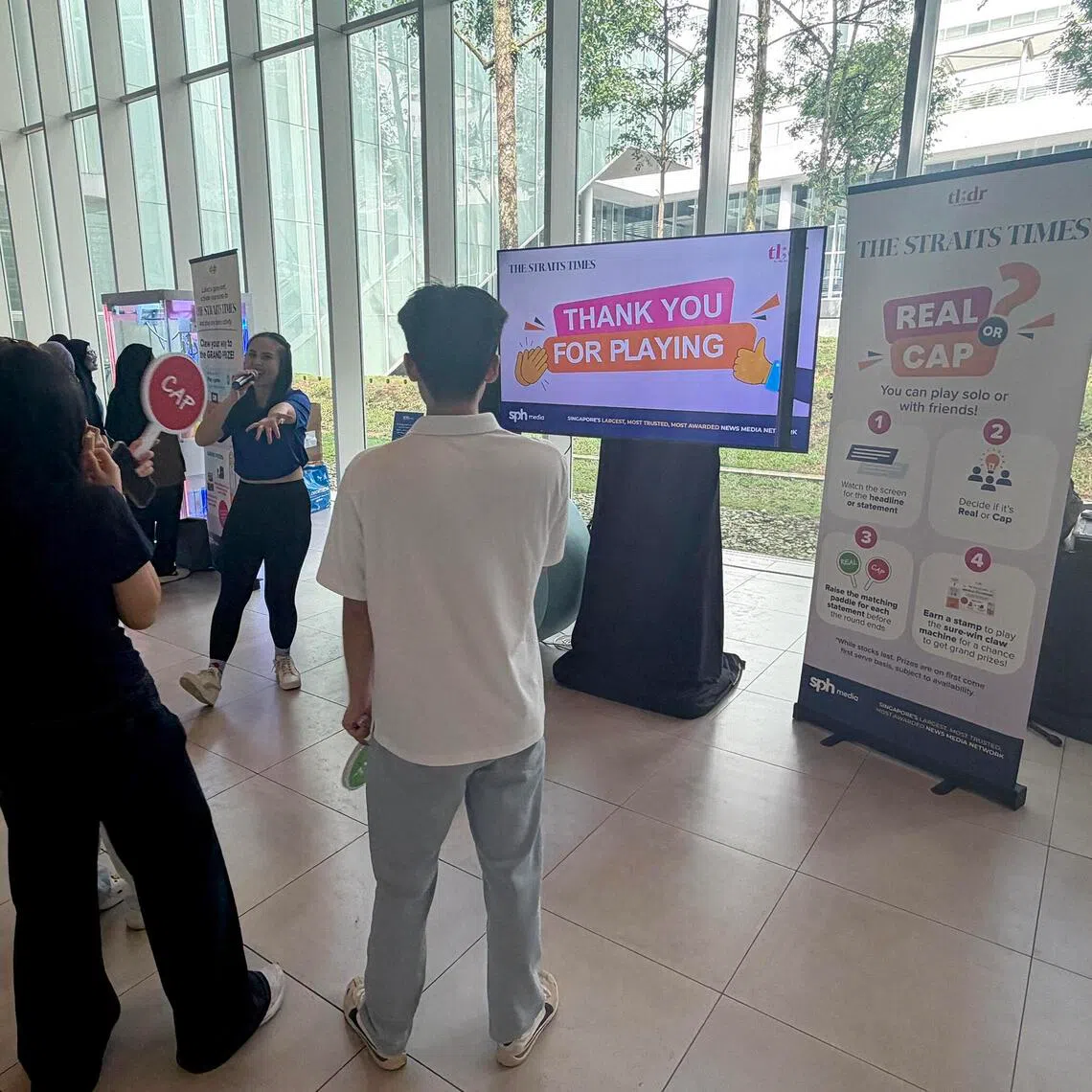 Republic Polytechnic students playing a quiz at a Straits Times roadshow.