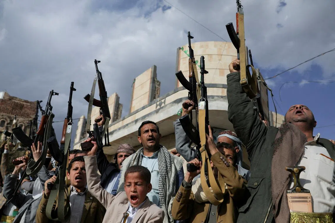 Houthi supporters hold up their weapons during a protest against Israel's blockade of aid into the Gaza Strip, in Sanaa, on March 11.