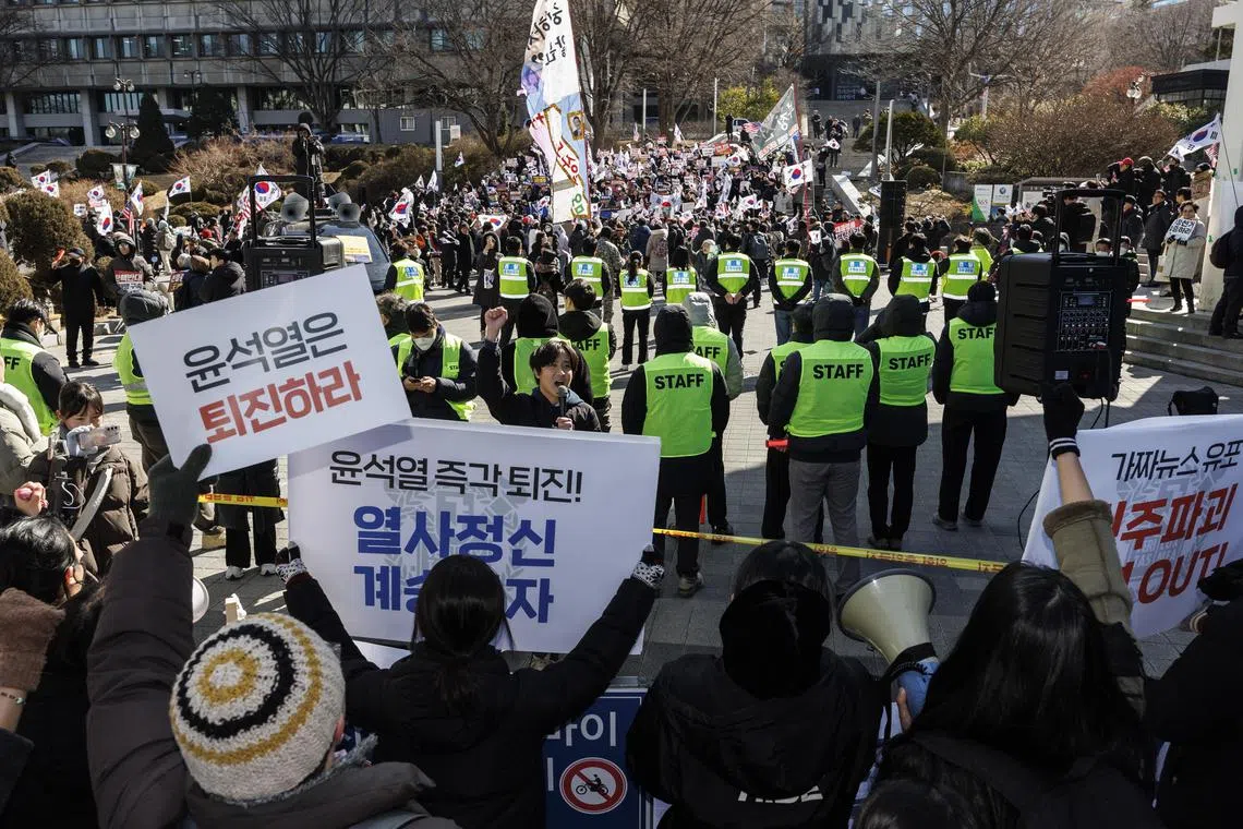 Protesters take part in rallies for and against President Yoon Suk Yeol's impeachment in connection to his short-lived imposition of martial law at Seoul National University in southern Seoul, South Korea. 
