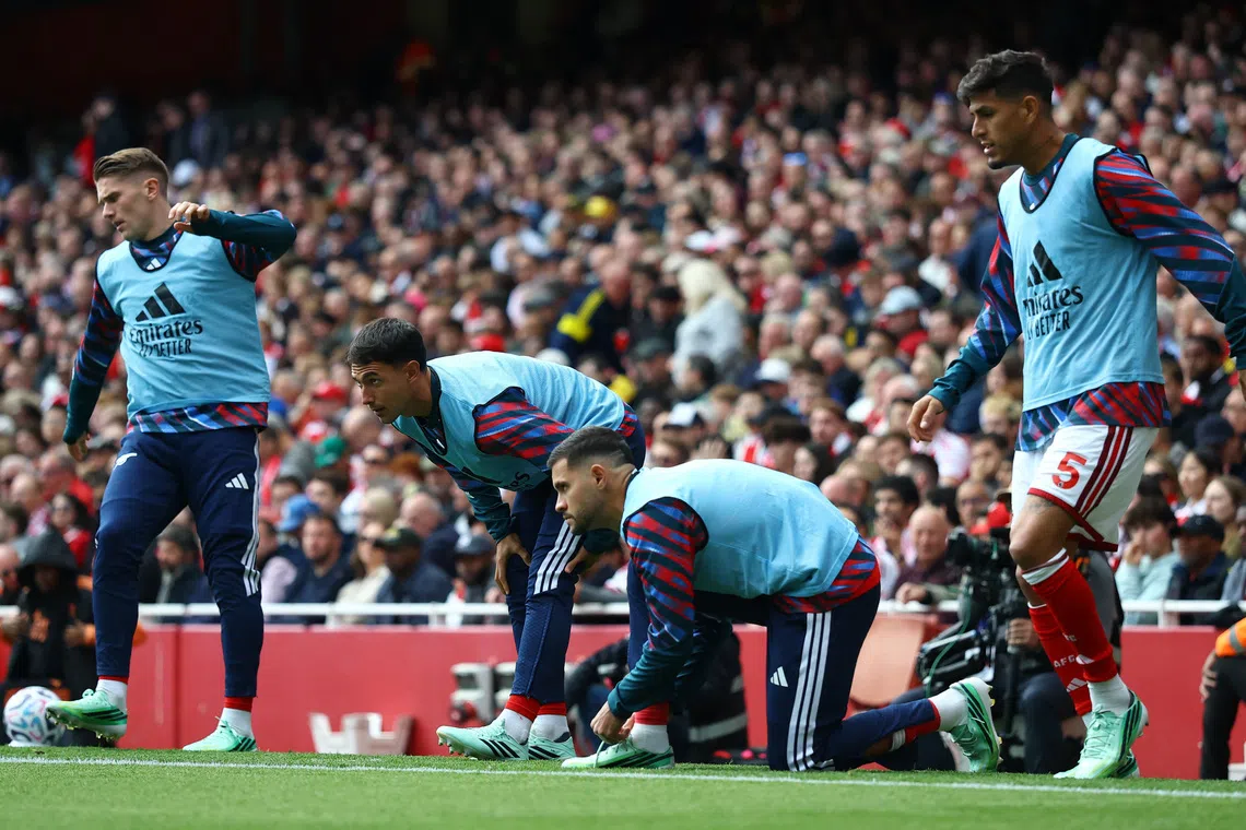 Arsenal’s Viktor Gyokeres, Martin Zubimendi, Bruno Guimaraes and Piero Hincapie warm up as substitutes during their match against Leeds United on Oct 10.