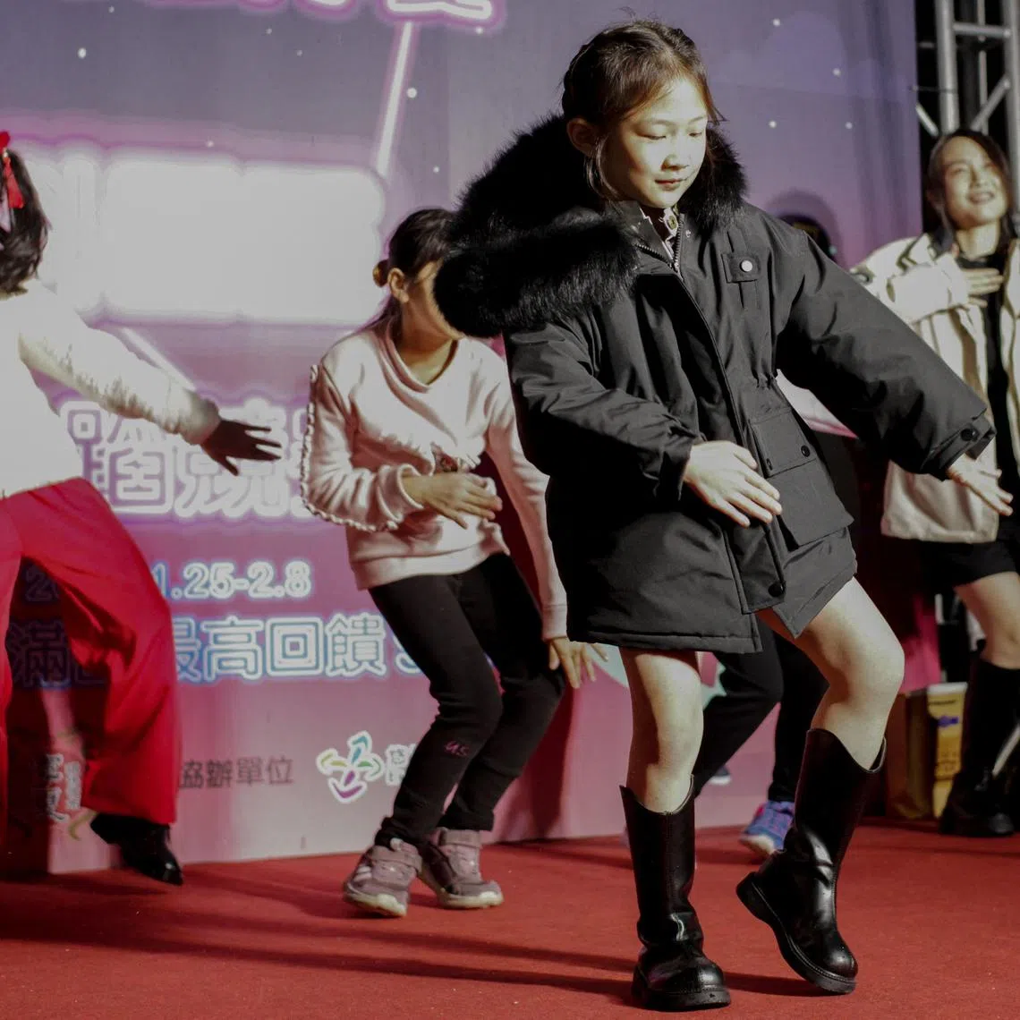 A girl perform the Kemusan or Subject 3 dance made popular on the Douyin platform at the Ningxia Night Market in Taipei on January 25, 2024.
