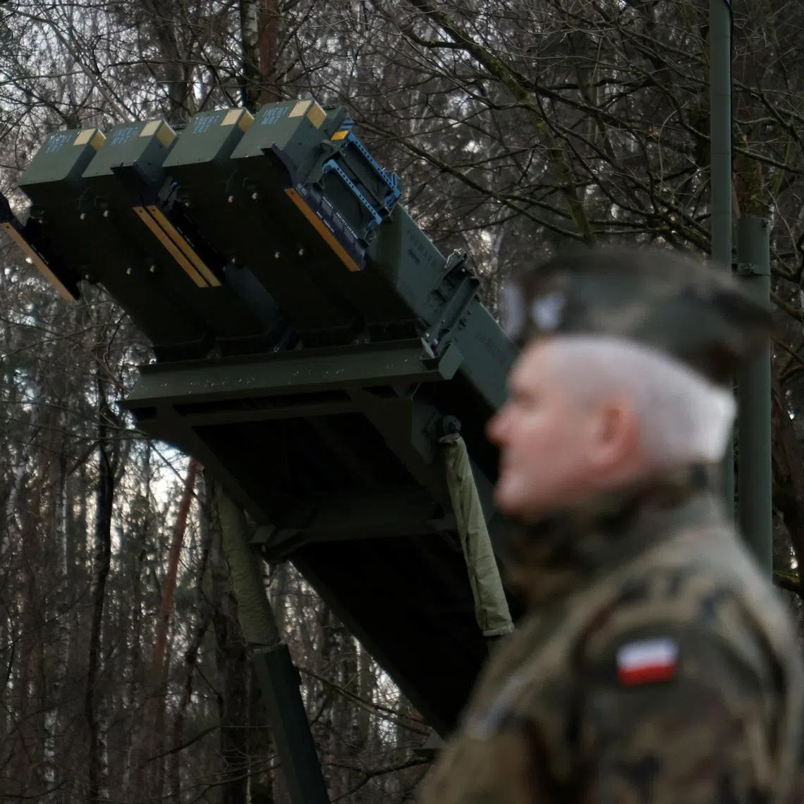 Polish army general stands in front of the surface-to-air missile launcher, the Patriot (Wisla) system, newly added into the Integrated Battle Command System (IBCS) at an army base in Sochaczew, Poland, December 18, 2024. REUTERS/Kuba Stezycki