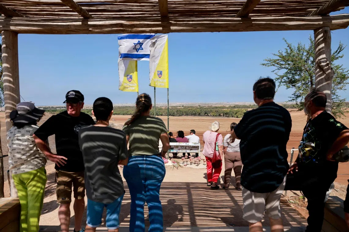 Visitors at a memorial site for fallen soldiers in southern Israel looking towards the devastated Gaza Strip on Oct 11.