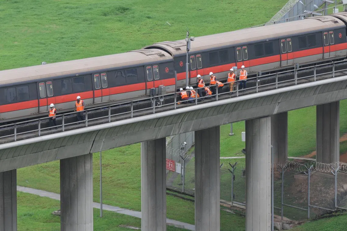 SMRT personnel inspecting the carriages of the affected train outside Ulu Pandan Depot at around 1.45pm on Sept 25, 2024.