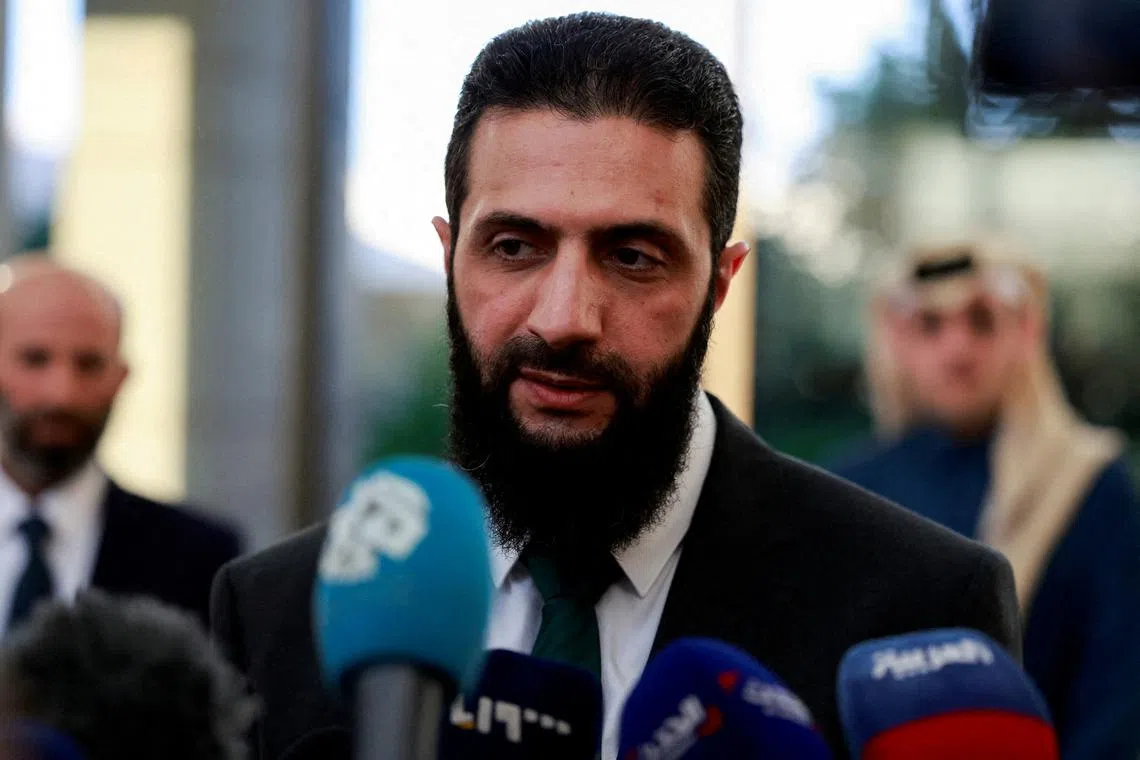 FILE PHOTO: Syria's de facto leader Ahmed al-Sharaa, also known as Abu Mohammed al-Golani, speaks to the media during a meeting with Qatar's Minister of State Mohammed bin Abdulaziz Al-Khulaifi, after the ousting of Syria's Bashar al-Assad, in Damascus, Syria, December 23, 2024. REUTERS/Ammar Awad//File Photo