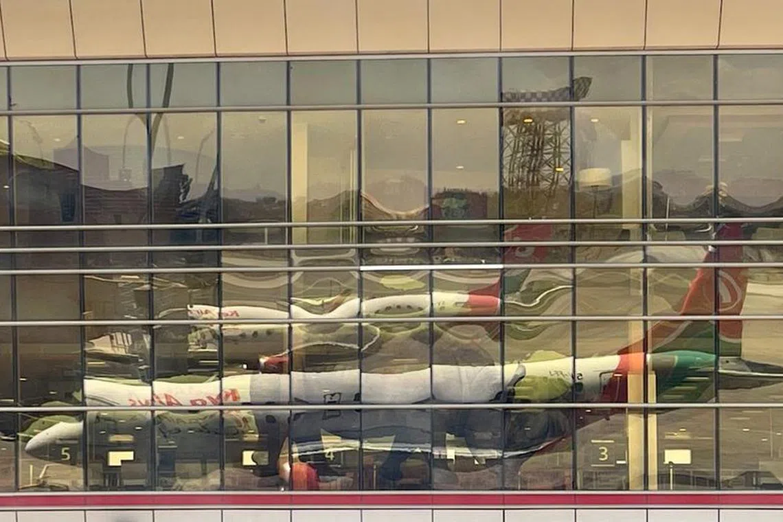 FILE PHOTO: A reflection from the windows show Kenya Airways planes parked at terminal within the Jomo Kenyatta International Airport near Nairobi, Kenya March 7, 2023. REUTERS/Thomas Mukoya/File Photo