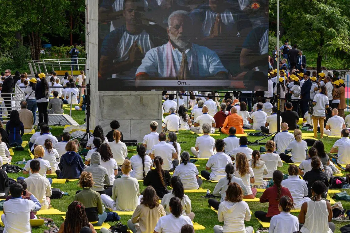 India's Prime Minister Narendra Modi (on screen) leads a session during International Yoga Day at the UN headquarters in New York on June 21.