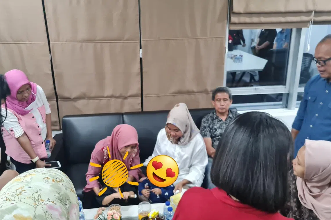 Ms Dian Hartono (left, in pink outfit) and Ms Siti Mauliah (right, in white outfit) holding each others' biological sons in this handout photo taken at Bogor police station on Aug 26. The two mothers from Indonesia's West Java province have agreed to give back their babies to the respective birth parents after cross DNA tests confirmed there had been a case of accidental cradle swapping 14 months ago.