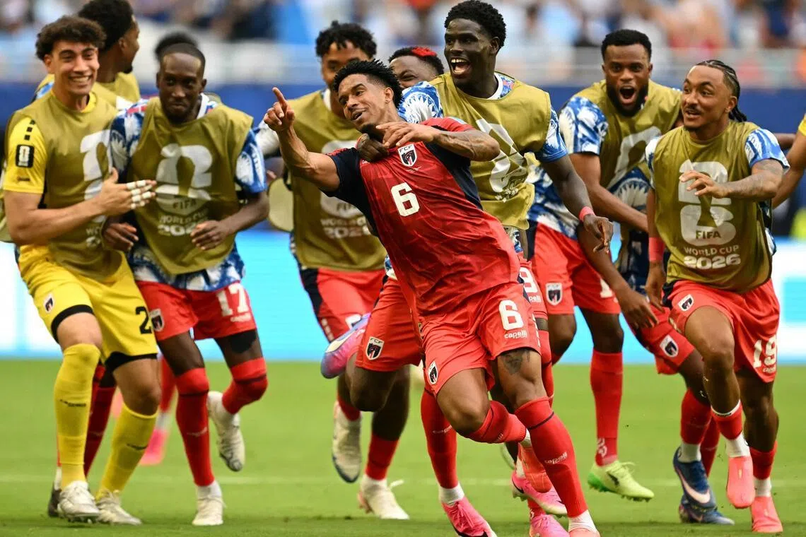 Cape Verde's midfielder Kevin Pina celebrates with teammates after scoring his team's first goal during the 2-2 draw against Uruguay at the Miami Stadium.
