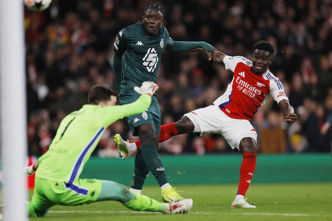 Soccer Football - Champions League - Arsenal v AS Monaco - Emirates Stadium, London, Britain - December 11, 2024 Arsenal's Bukayo Saka scores their second goal against AS Monaco on Dec 11.