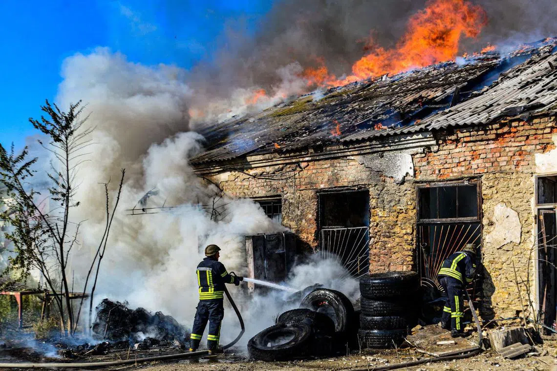Firefighters put out a blaze at a warehouse after shelling in Ukraine's Kherson.