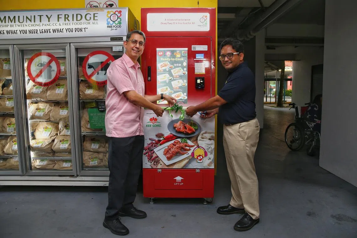 Nee Soon GRC MP Muhammad Faishal Ibrahim (left) and Free Food For All board member Mohamad Faiz Selamat launching the vending machine.