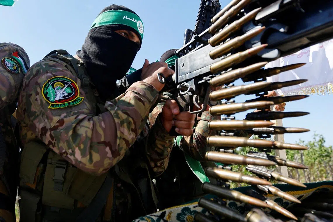 FILE PHOTO: A Palestinian fighter from the armed wing of Hamas takes part in a military parade to mark the anniversary of the 2014 war with Israel, near the border in the central Gaza Strip, July 19, 2023. REUTERS/Ibraheem Abu Mustafa/File Photo