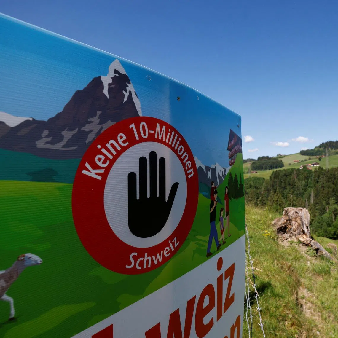 A sign sits in a field, on the day of the vote on a plan backed by the right-wing Swiss People's Party (SVP) to limit population growth to 10 million inhabitants, near Hundwil, Switzerland, June 14, 2026.  REUTERS/Michaela Stache