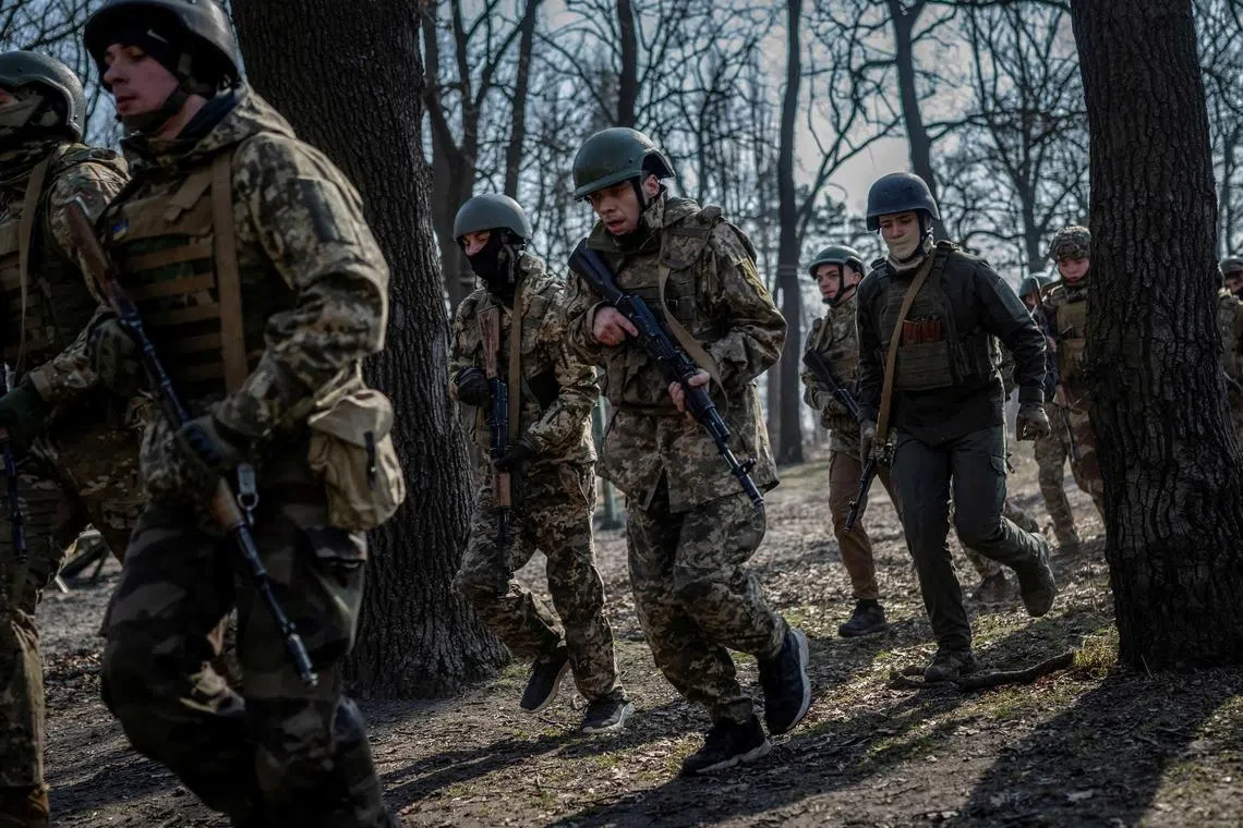FILE PHOTO: Volunteers who aspire to join the 3rd Separate Assault Brigade of the Ukrainian Armed Forces take part in a basic training, amid Russia's attack on Ukraine, in Kyiv region, Ukraine March 5, 2024. REUTERS/Viacheslav Ratynskyi/File Photo