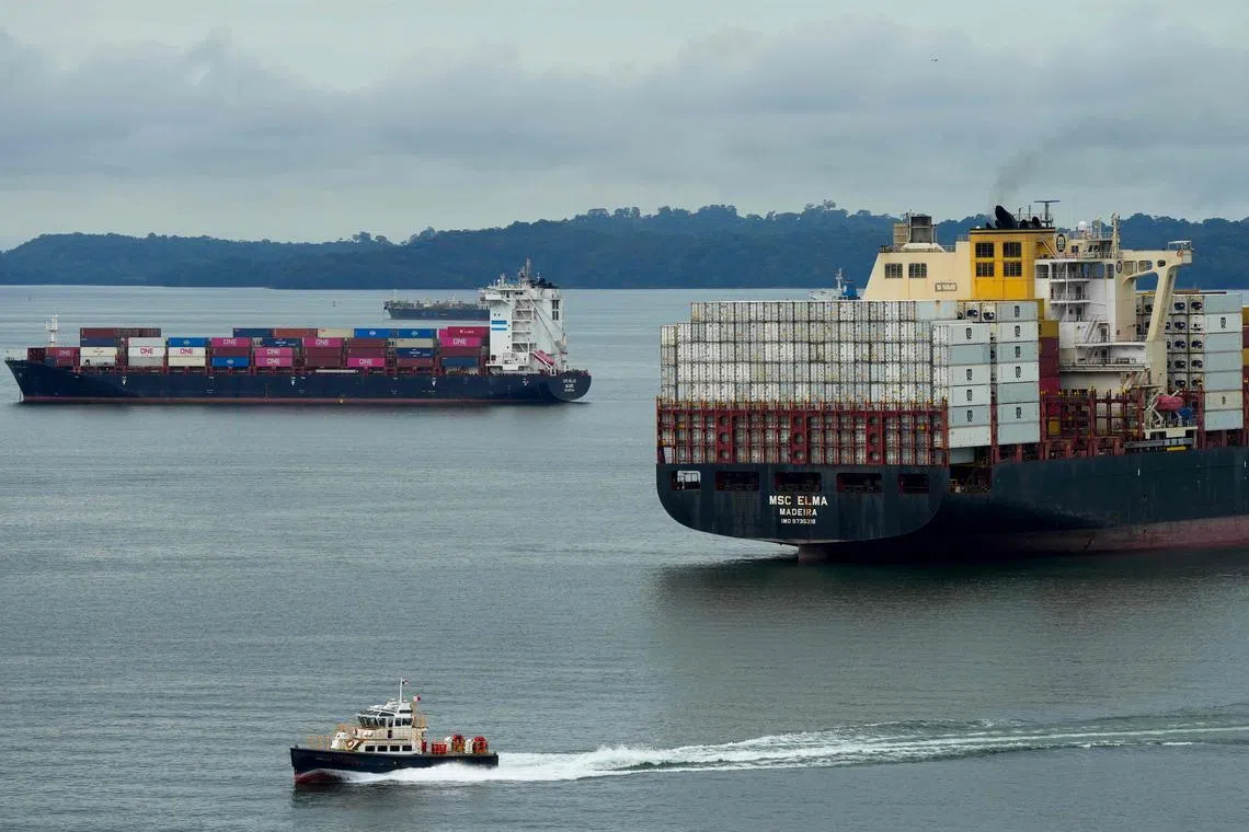 Cargo ships sail on Gatun Lake near the Agua Clara Locks of the Panama Canal in Panama, on Dec 28.