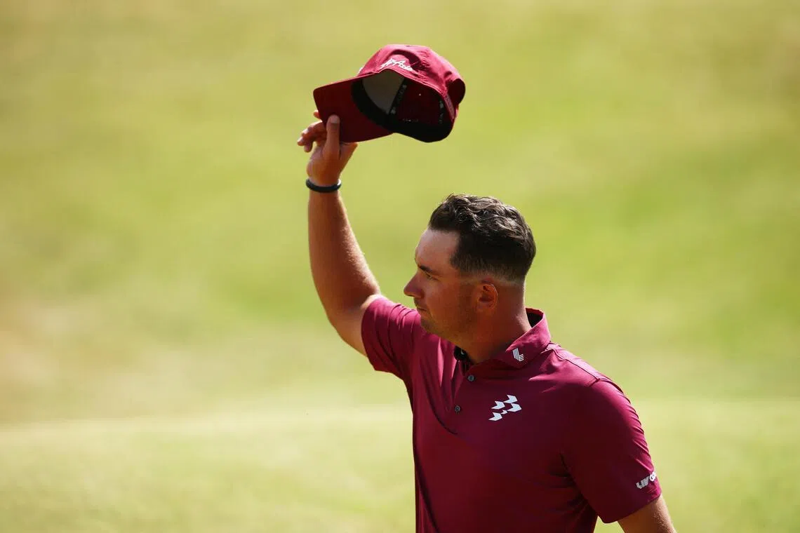Australia’s Lucas Herbert acknowledges spectators after making his putt for bogey on the 18th hole during the second round of the British Open.
