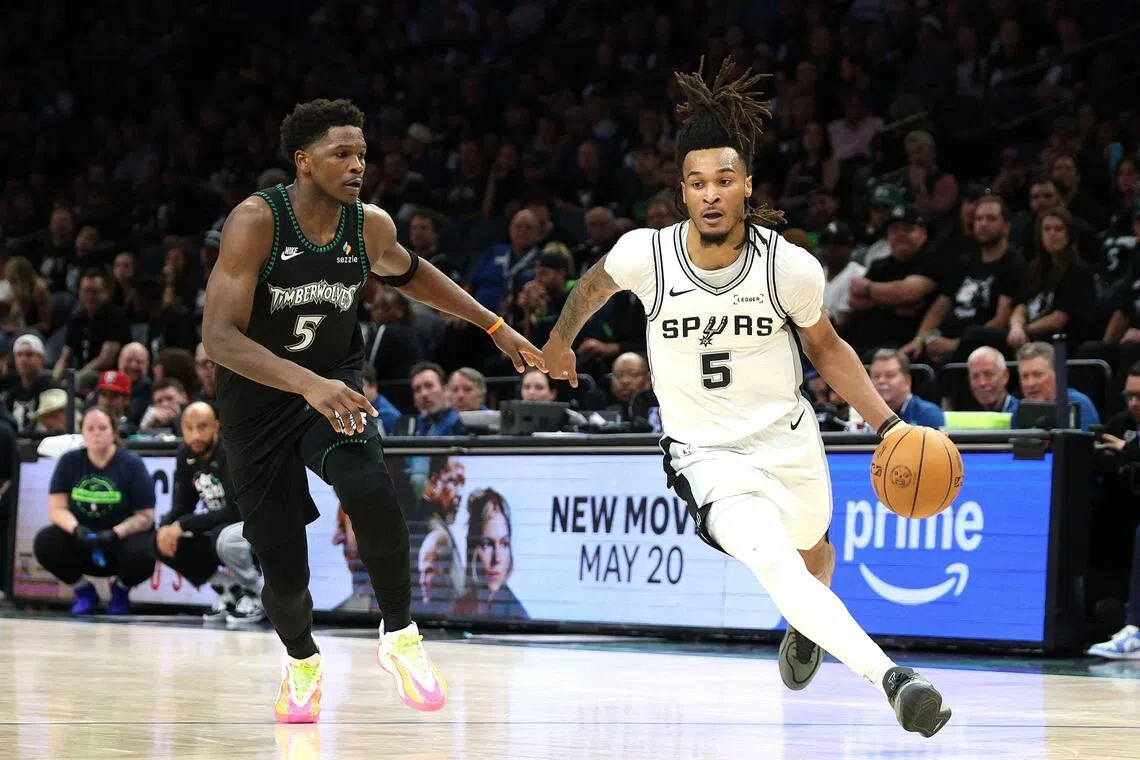 Stephon Castle of the San Antonio Spurs drives around Anthony Edwards of the Minnesota Timberwolves during the fourth quarter in Game 6.