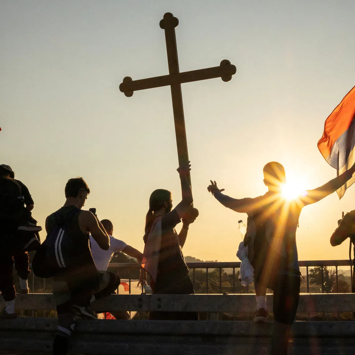 Students from Gornji Milanovac wave flags during their walk to Belgrade near the village of Bogovadja, Serbia, October 19, 2026. REUTERS/Marko Djurica