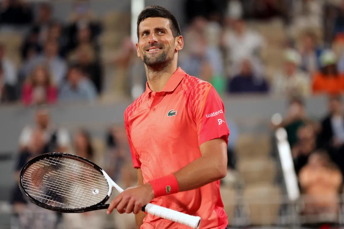 Djokovic reacts after winning against Marton Fucsovics of Hungary.