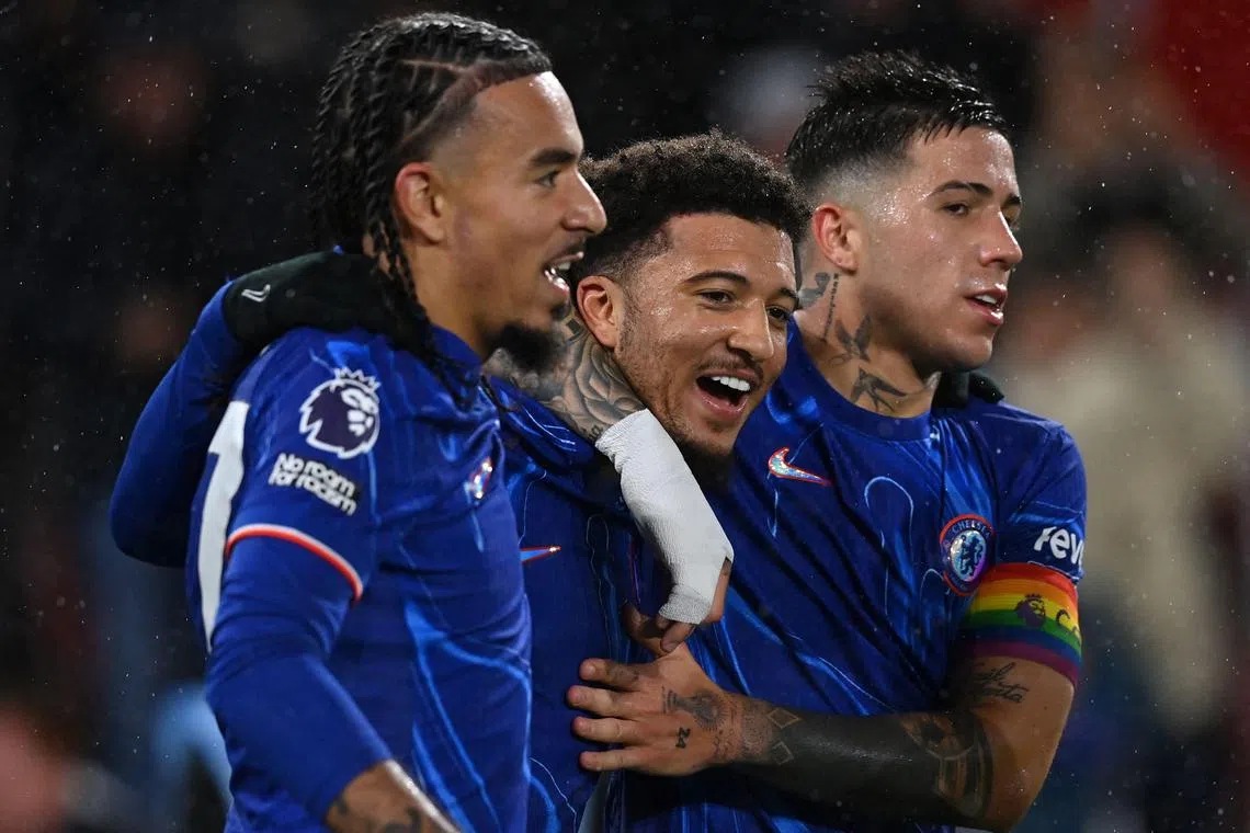 Chelsea's Jadon Sancho (centre) celebrates scoring the team's fifth goal with defender Malo Gusto (right) and midfielder Enzo Fernandez.
