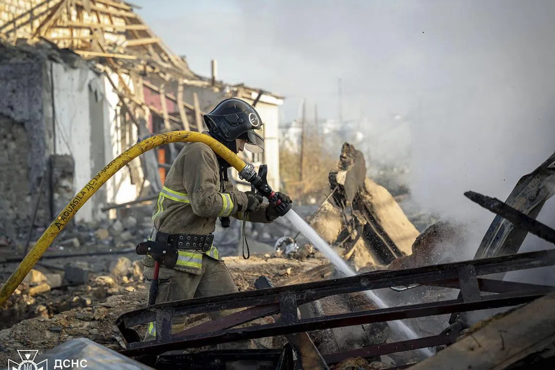 Ukrainian rescuers working at the site of an air strike by Russia in Odesa, on Nov 17.