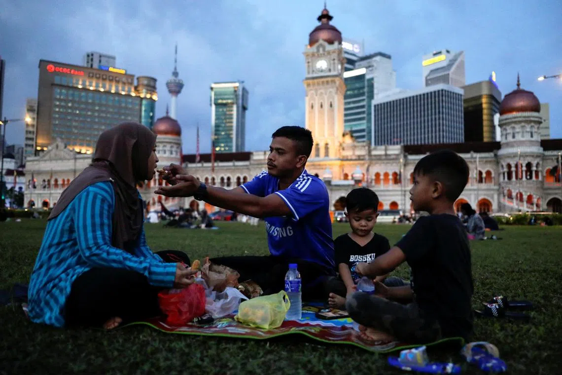 Zulhafiszam Zaidi, 30, and his wife Syafiqah Zahida, 31, break their fast during the holy month of Ramadan in Kuala Lumpur, Malaysia March 24, 2023. REUTERS/Hasnoor Hussain