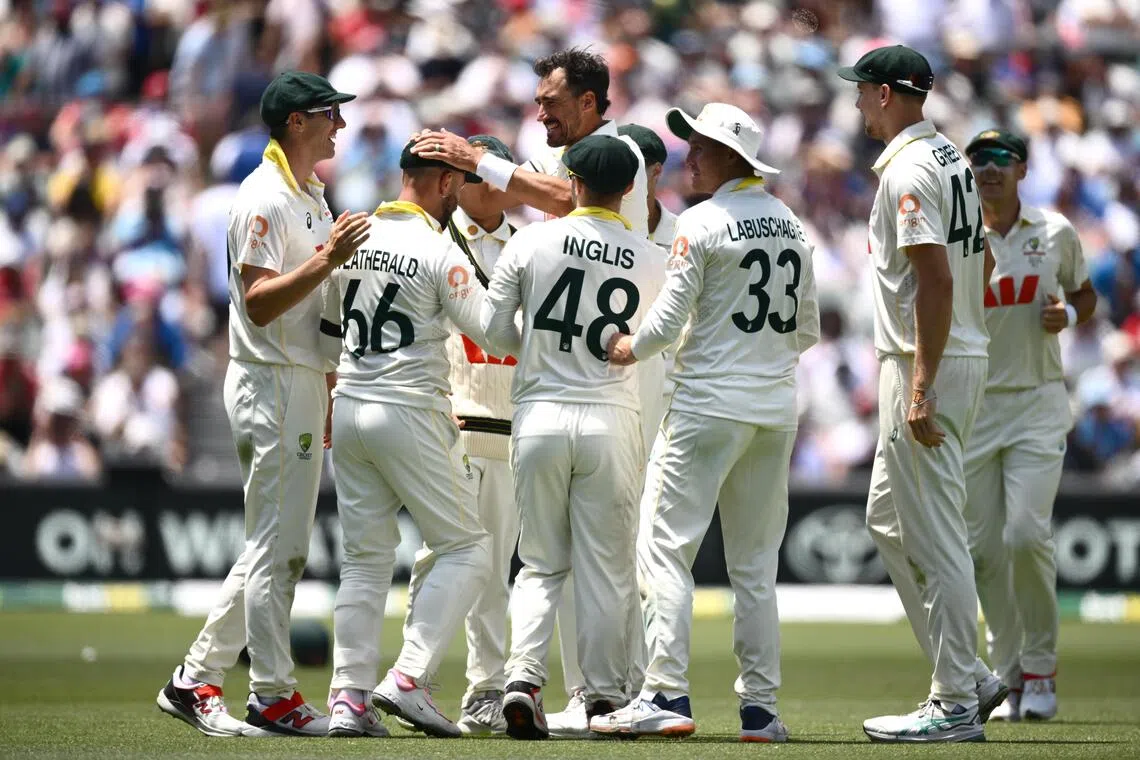 Mitchell Starc of Australia (centre) celebrates taking the wicket of Jofra Archer of England during Day 5 of the third men’s Ashes Test at the Adelaide Oval in Adelaide on Dec 21, 2025.