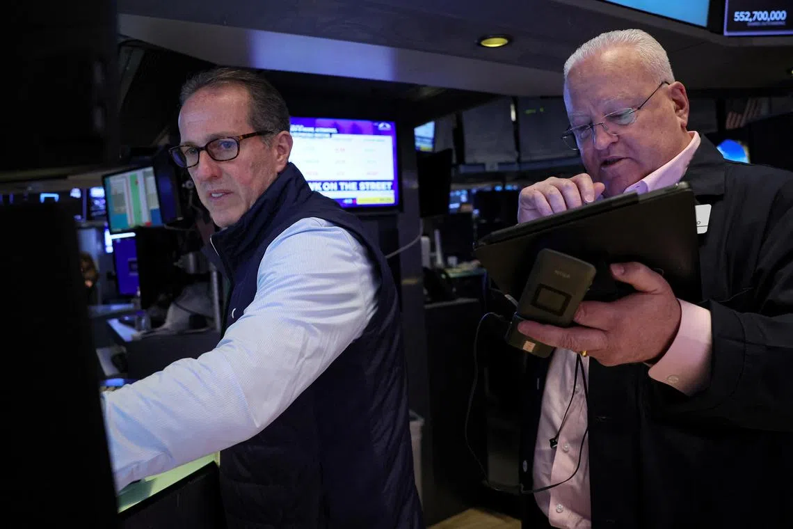 Traders work on the floor of the New York Stock Exchange, in New York City.