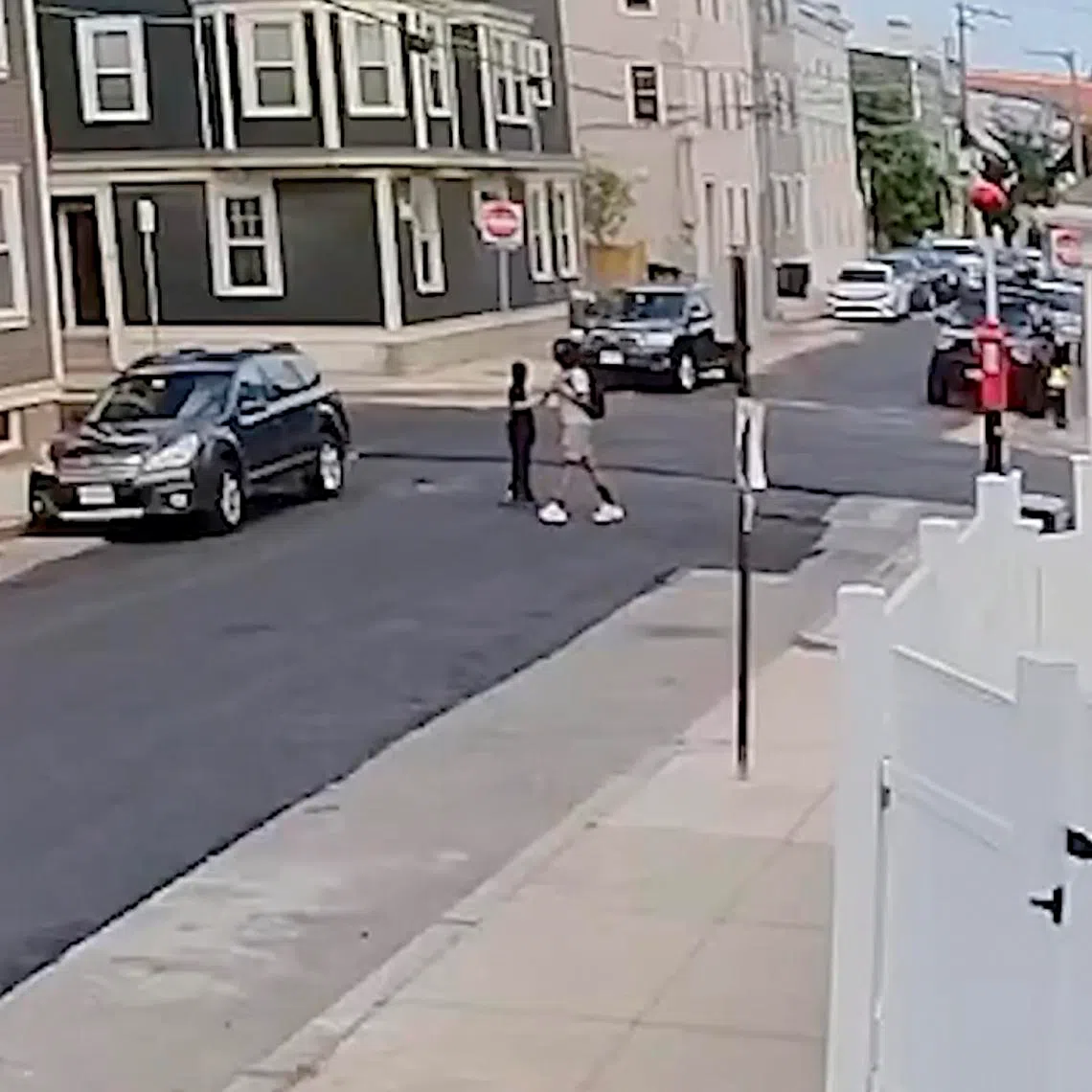 In a video still from the Boston Police Department, the police said that two boys made "several passes" by a lemonade stand before robbing it on June 10.