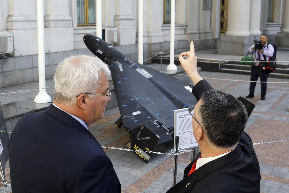 Ukrainian Foreign Minister Andrii Sybiha (left) and visiting Israeli Foreign Minister Gideon Saar viewing a Russian "Geran" drone - a copy of an Iranian-made Shahed-136 - in Kyiv, Ukraine, on July 23.