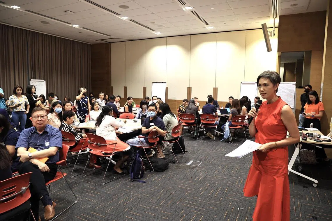 Minister Josephine Teo speaking with partners at an engagement session to better understand the digital needs of low-income households and seniors.