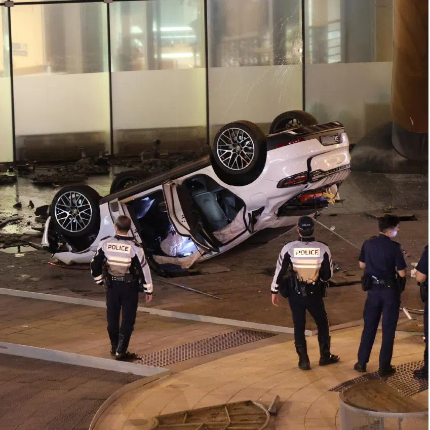 Photos of the Suntec City accident posted on social media show an overturned light-coloured car, with debris scattered in the vicinity.