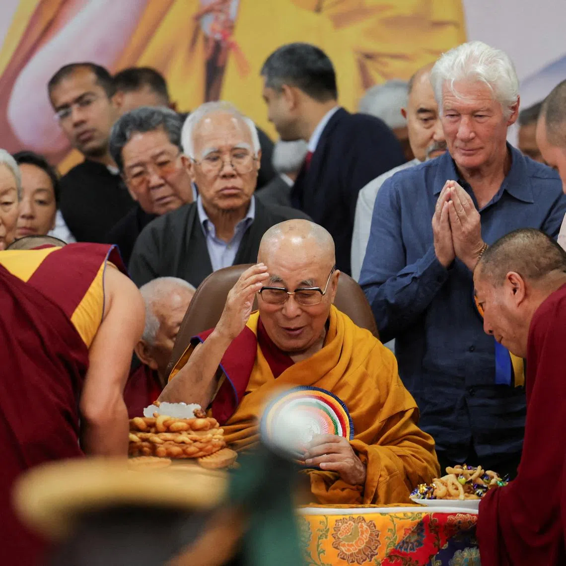 FILE PHOTO: Tibetan spiritual leader, the 14th Dalai Lama, is served food on his 90th birthday celebration at the Tsuglagkhang, also known as the Dalai Lama Temple complex, in the northern town of Dharamshala, India, July 6, 2025. REUTERS/Anushree Fadnavis/File Photo