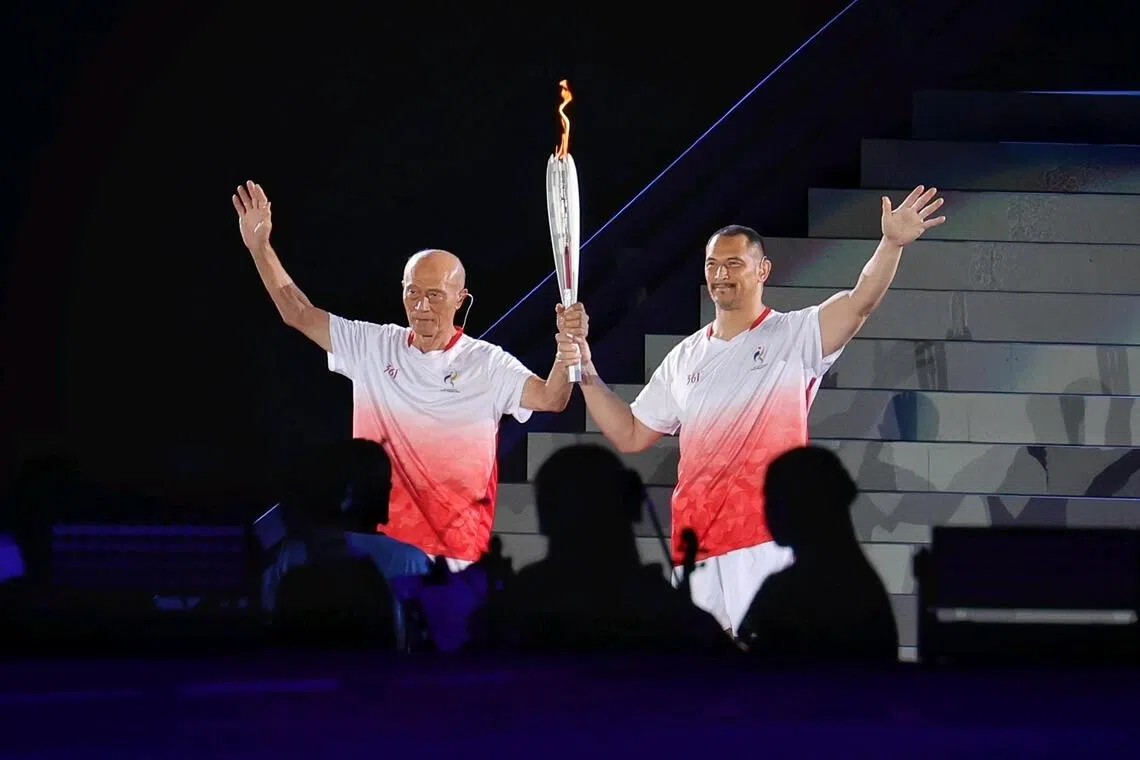 Five-time Asian Games hammer throw champion Shigenobu Murofushi (left) and his son Olympic hammer throw champion Koji running the final leg of the torch for the lighting of the cauldron during the opening ceremony of the Aichi-Nagoya 2026 Asian Games at the Paloma Mizuho Stadium in Nagoya, Japan on Sept 19, 2026. ST PHOTO: KEVIN LIM pixag19
