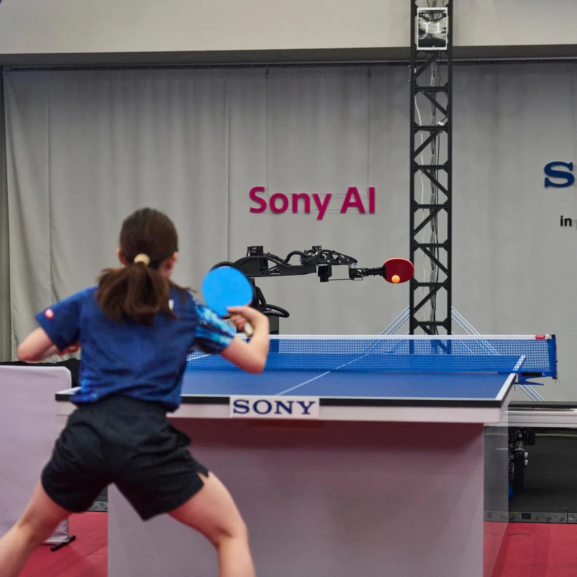 Sony AI autonomous robot Ace fires a shot back to its human opponent, table tennis player Minami Ando, during a match in December 2025 in Tokyo, Japan, as seen in this photograph released on April 22, 2026. Sony AI/Handout via REUTERS