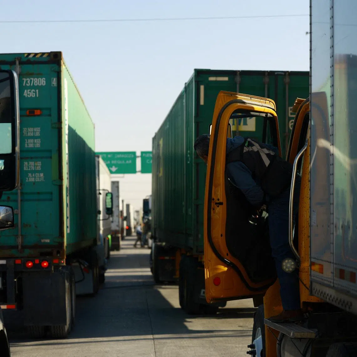 Trucks wait in a queue at the Zaragoza-Ysleta border crossing bridge to cross into the U.S. in Ciudad Juarez, Mexico March 12, 2026. REUTERS/Jose Luis Gonzalez