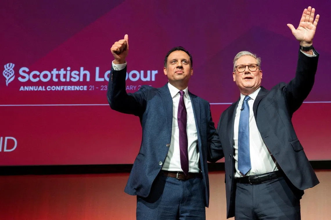 British Prime Minister Keir Starmer with Scottish Labour party leader Anas Sarwar react on stage after Starmer's keynote speech during the Scottish Labour Party annual conference at the SEC (Scottish Event Campus), in Glasgow, Scotland, Britain, February 23, 2025. REUTERS/Lesley Martin/File Photo