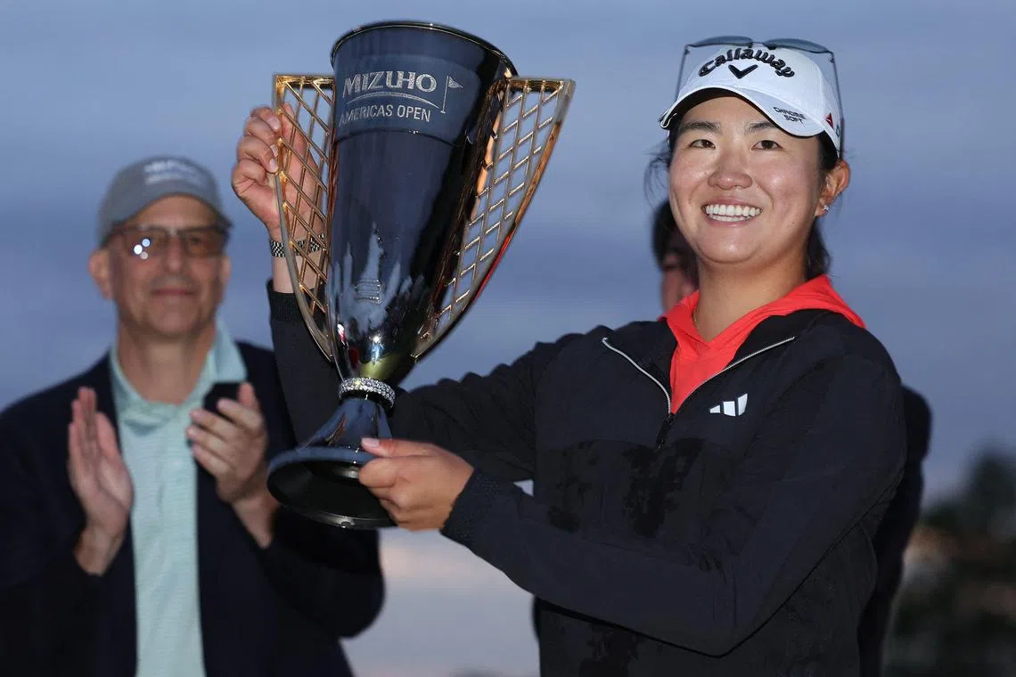 Rose Zhang of the United States posing with the trophy after winning the Mizuho Americas Open in a playoff with compatriot Jennifer Kupcho.