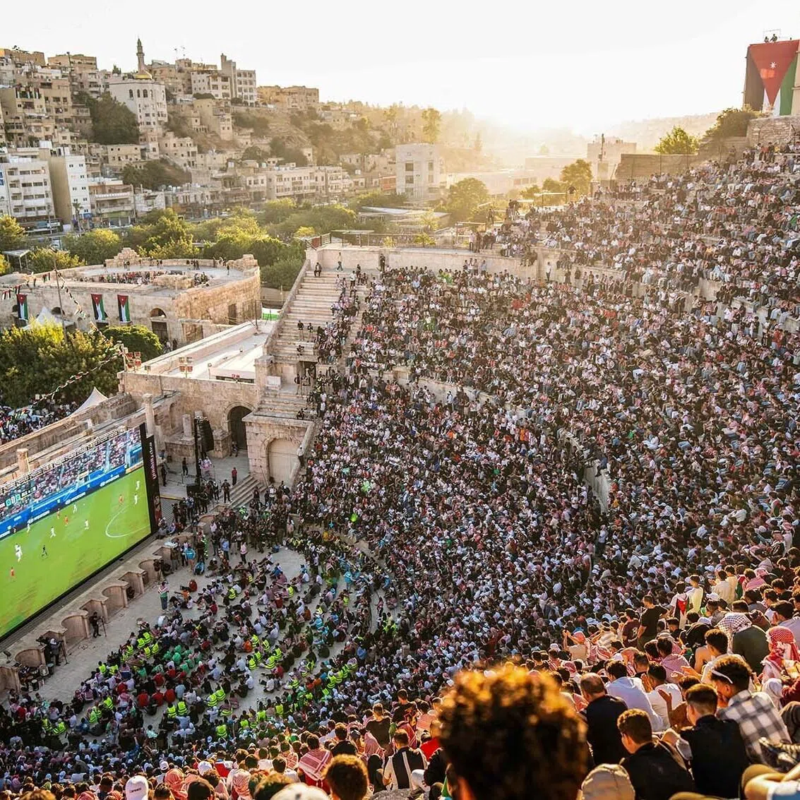 Jordanian football fans gathering to watch on giant screens their national team's World Cup football match against Algeria at Amman's 2nd-century Roman amphitheatre early on June 23. 