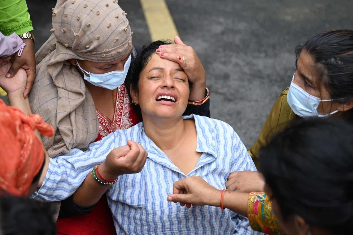 Mona Khadka grieves the death of her son, Ayush, who died in the aftermath of flash floods in Nepal, outside a mortuary in Nepal’s Chitwan district on August 31, 2026. Nepal was burying on August 31 some of the hundreds of bodies retrieved after a deadly, tsunami-like flood crashed through the Himalayan region, sweeping away villages and leaving thousands still missing. Distraught families have packed rescue stations and hospitals in search of their missing relatives, while others have faced the grim task of identifying bodies at overflowing morgues. (Photo by PRAKASH MATHEMA / AFP)