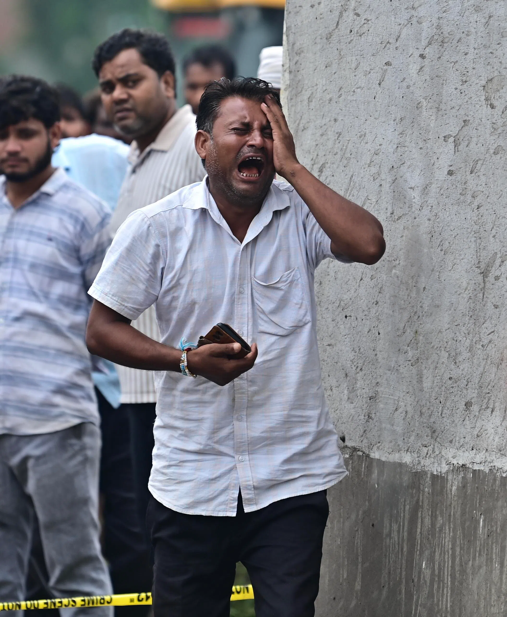 The relative of a victim mourns as rescue work continues at Pipri, in India’s Uttar Pradesh state.