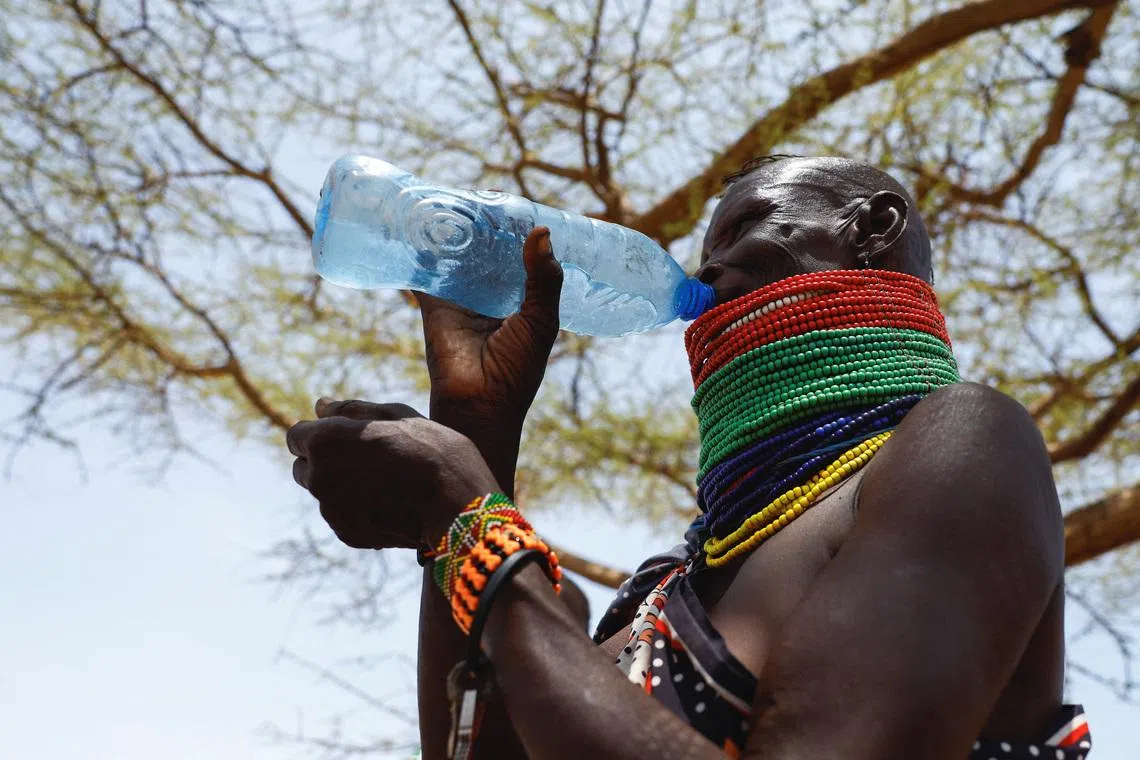 A member of the indigenous Turkana Nilotic community drinks water after arriving at a food distribution centre by the World Food Programme (WFP) following a prolonged dry spell, below-average rainfall causing food insecurity, water scarcity, and livestock losses; to reduce the impact of the ongoing drought situation, providing timely access to nutritious food to the population, at the Kenya Oil village near Lodwar in Turkana County, Kenya February 17, 2026. REUTERS/Thomas Mukoya