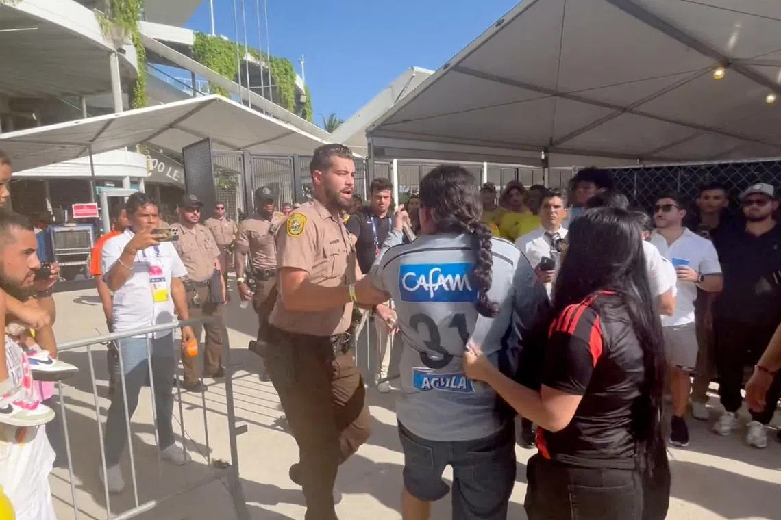 FILE PHOTO: People get into a scuffle with the police, amid reports of fans rushing the gates before the final match of Copa America between Argentina and Colombia at Hard Rock Stadium, in Miami, Florida, U.S., July 14, 2024, in this screengrab obtained from a social media video. sammbonu/via REUTERS/File Photo