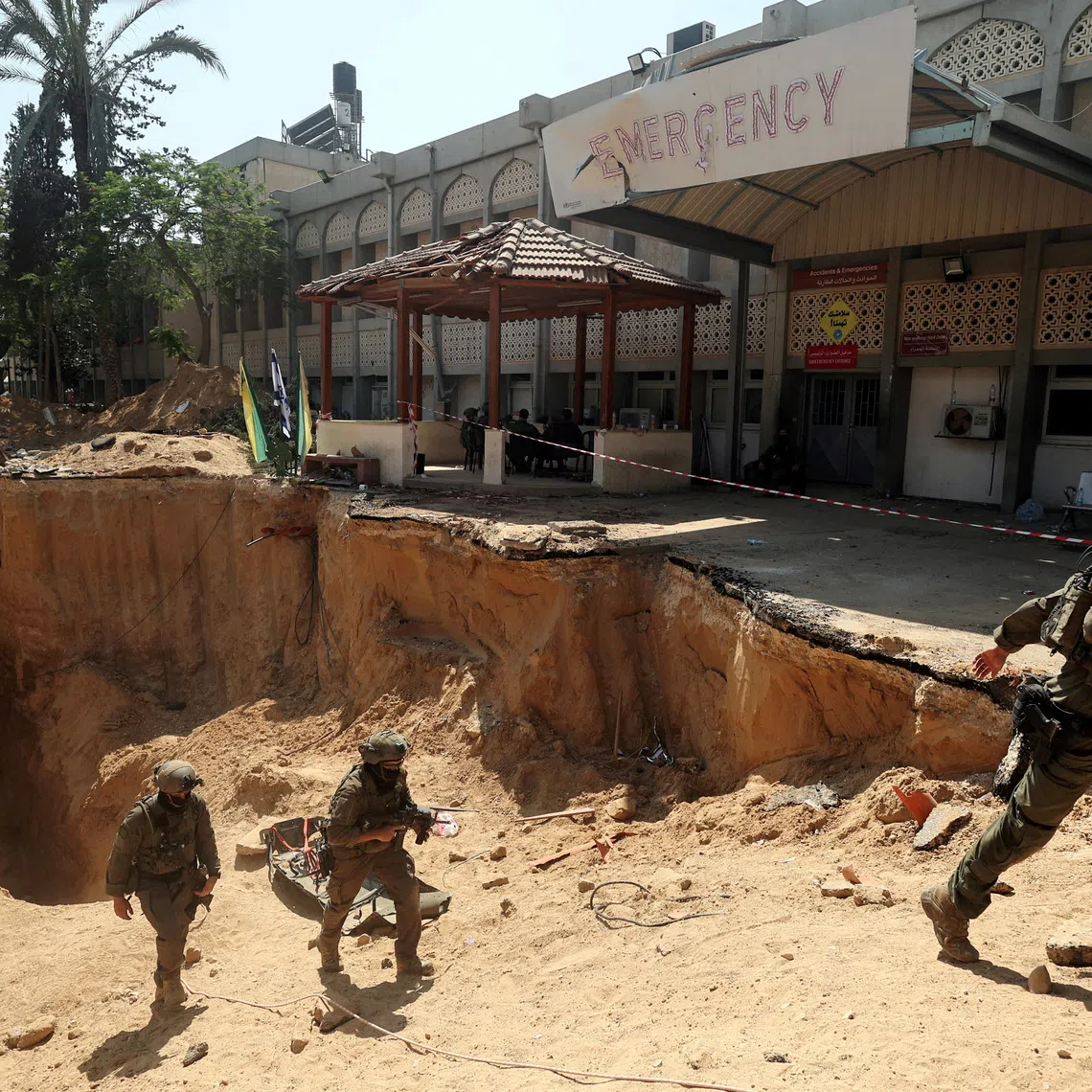 FILE PHOTO: Israeli soldiers walk out from a tunnel underneath the European Hospital in Khan Younis at the Gaza Strip, amid the ongoing ground operation of the Israeli army against Palestinian Islamist group Hamas, June 8, 2025. REUTERS/Ronen Zvulun/File Photo