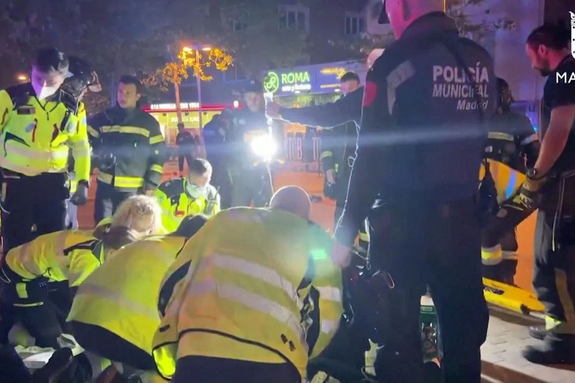 Rescuers work outside a restaurant following a fire in Madrid, on April 21, 2023.
