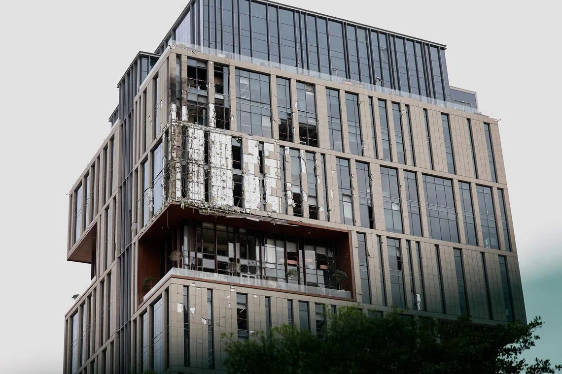 A view of the damaged part of one of the buildings of the Dubai International Financial Centre (DIFC) caused by debris from an interception of an Iranian drone attack in Dubai, United Arab Emirates on March 13. 